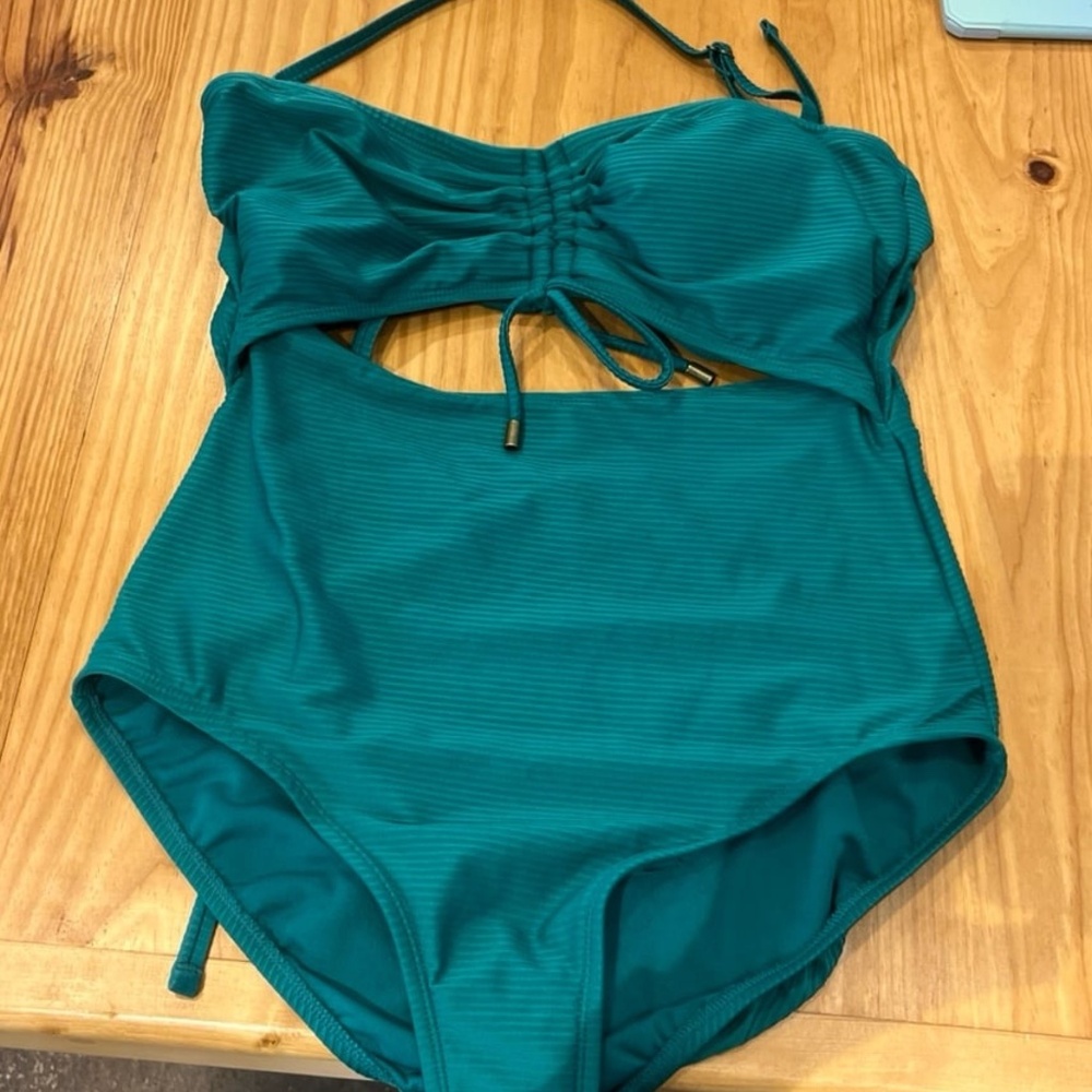 Green one piece swimsuit with cutouts